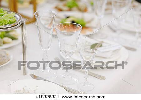 Stock Image - Wedding place setting with drinking glasses. Fotosearch
