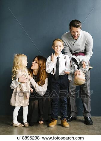 Well-dressed family with three children View Large Photo Image Stock Photo - Well-dressed family with three children. Fotosearch