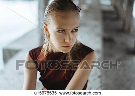 Stock Photography - Wet young woman underneath pier. Fotosearch