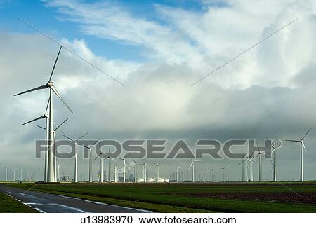 Stock Image - Wind turbines around the Delfzijl harbour area, Delfzijl, Groningen, Netherlands. Fotosearch