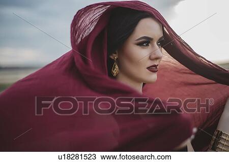Windswept woman wearing red headscarf and lipstick View Large Photo Image Stock Image - Windswept woman wearing red headscarf and lipstick. Fotosearch