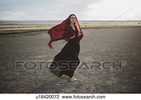 Windswept woman wearing red headscarf View Large Photo Image Stock Image - Windswept woman wearing red headscarf. Fotosearch