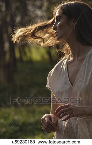 Stock Photo - Windswept woman with brown hair. Fotosearch