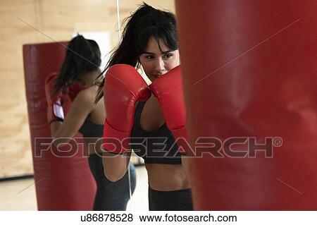 Woman boxing with punching bag View Large Photo Image Stock Photo - Woman boxing with punching bag. Fotosearch