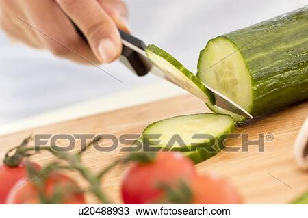 Woman chopping fresh cucumber. View Large Photo Image Stock Image - Woman chopping fresh cucumber.. Fotosearch