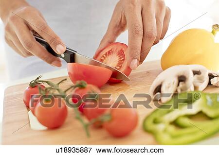 Woman chopping fresh tomatoes. View Large Photo Image Stock Photo - Woman chopping fresh tomatoes.. Fotosearch