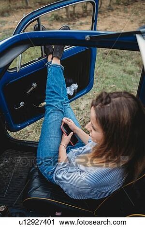 Woman daydreaming inside car View Large Photo Image Stock Image - Woman daydreaming inside car. Fotosearch