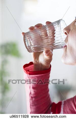 Woman drinking glass of water to hydrate. View Large Photo Image Stock Photo - Woman drinking glass of water to hydrate.. Fotosearch
