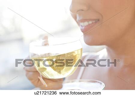 Stock Photograph - Woman drinking herbal tea.. Fotosearch