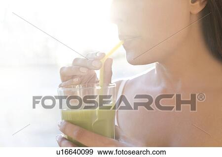Stock Photo - Woman drinking smoothie.. Fotosearch