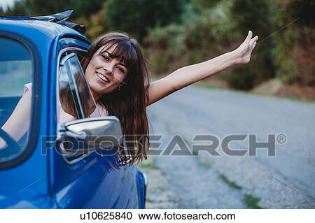 Woman driving, sticking head and arm out of car window View Large Photo Image Stock Image - Woman driving, sticking head and arm out of car window. Fotosearch