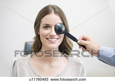Woman having her eyes tested. View Large Photo Image Stock Image - Woman having her eyes tested.. Fotosearch