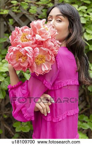 Stock Image - Woman holding bouquet of flowers. Fotosearch