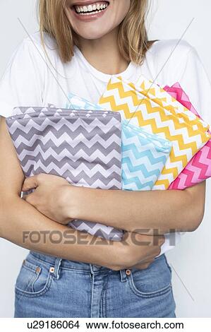 Woman holding colorful zigzag fabrics View Large Photo Image Picture - Woman holding colorful zigzag fabrics. Fotosearch