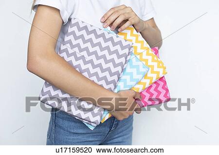Woman holding colorful zigzag fabrics View Large Photo Image Stock Image - Woman holding colorful zigzag fabrics. Fotosearch