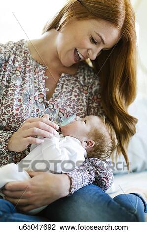 Woman holding her newborn son View Large Photo Image Stock Image - Woman holding her newborn son. Fotosearch