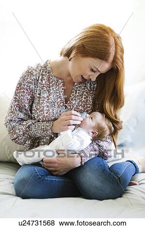 Stock Photo - Woman holding her newborn son. Fotosearch