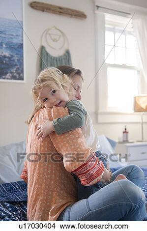 Woman hugging her son View Large Photo Image Picture - Woman hugging her son. Fotosearch