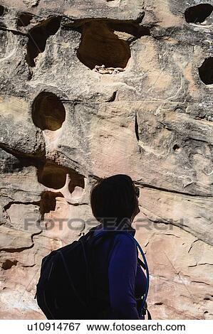 Woman in shadow by eroded rock in Capitol Reef National Park, USA View Large Photo Image Stock Photo - Woman in shadow by eroded rock in Capitol Reef National Park, USA. Fotosearch