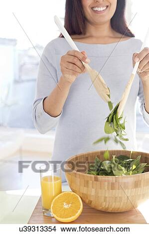 Picture - Woman making fresh salad.. Fotosearch