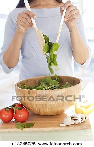 Stock Photography - Woman making fresh salad.. Fotosearch