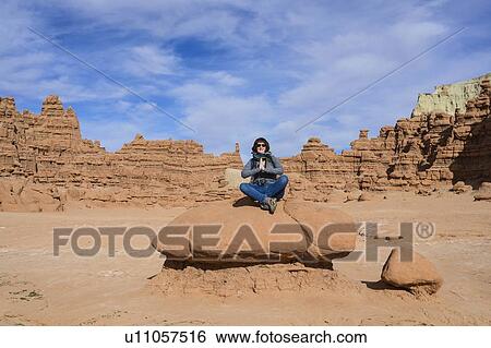 Woman meditating on rock in Goblin Valley State Park, Utah, USA View Large Photo Image Stock Photograph - Woman meditating on rock in Goblin Valley State Park, Utah, USA. Fotosearch