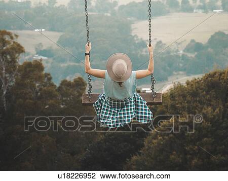 Stock Image - Woman on swing. Fotosearch