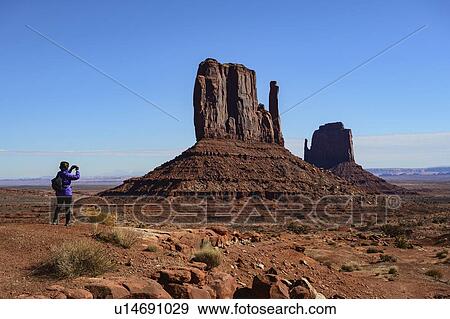 Woman photographing butte in Monument Valley, Arizona, USA View Large Photo Image Stock Photo - Woman photographing butte in Monument Valley, Arizona, USA. Fotosearch