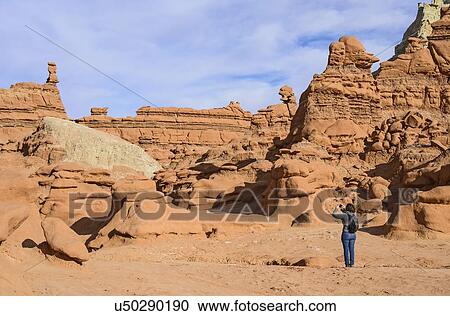 Woman photographing hoodoos in Goblin Valley State Park, Utah, USA View Large Photo Image Stock Image - Woman photographing hoodoos in Goblin Valley State Park, Utah, USA. Fotosearch