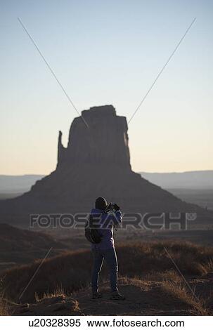 Stock Photography - Woman photographing Monument Valley in Arizona, USA. Fotosearch