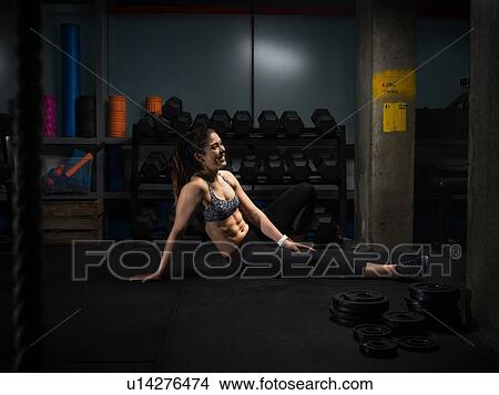 Picture - Woman resting in gym. Fotosearch