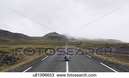 Woman sitting on highway in Iceland View Large Photo Image Stock Image - Woman sitting on highway in Iceland. Fotosearch