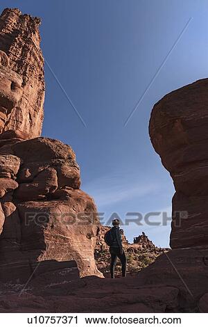Stock Image - Woman standing by Fisher Towers in Utah, USA. Fotosearch