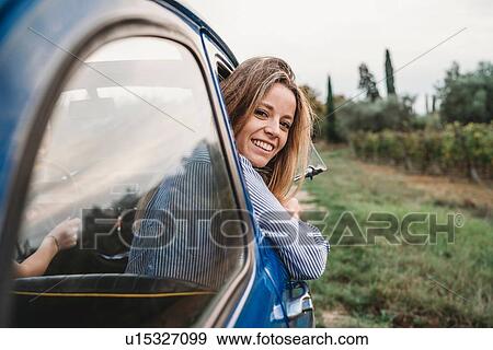 Woman sticking head out of car window View Large Photo Image Stock Photo - Woman sticking head out of car window. Fotosearch