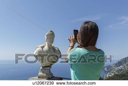Woman taking photograph of sculpture bust View Large Photo Image Stock Photo - Woman taking photograph of sculpture bust. Fotosearch