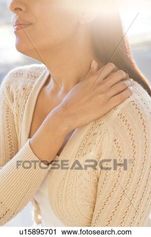 Woman touching shoulder in pain. View Large Photo Image Stock Image - Woman touching shoulder in pain.. Fotosearch