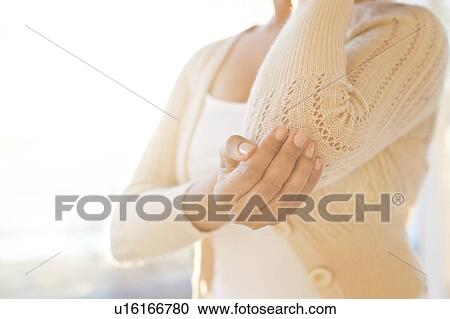 Woman touching sore elbow. View Large Photo Image Stock Image - Woman touching sore elbow.. Fotosearch