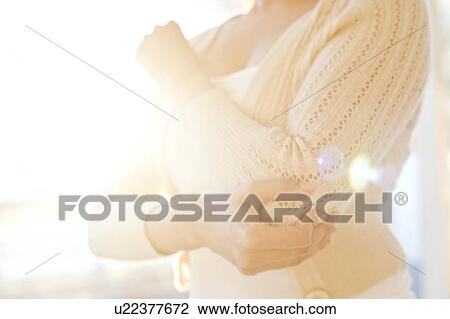 Woman touching sore elbow. View Large Photo Image Stock Image - Woman touching sore elbow.. Fotosearch