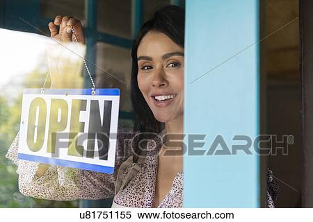 Woman turning open sign in shop window View Large Photo Image Stock Photography - Woman turning open sign in shop window. Fotosearch