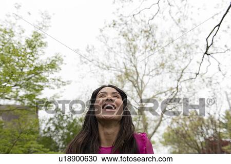 Stock Image - Woman under trees. Fotosearch