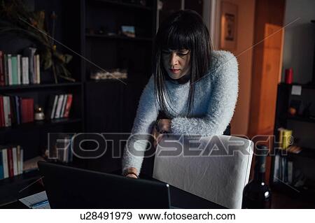 Woman using laptop in home office View Large Photo Image Stock Photo - Woman using laptop in home office. Fotosearch