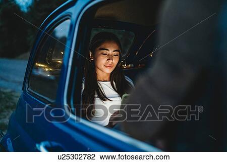 Woman using smartphone inside car View Large Photo Image Stock Image - Woman using smartphone inside car. Fotosearch