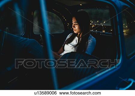 Woman using smartphone inside car View Large Photo Image Stock Photograph - Woman using smartphone inside car. Fotosearch
