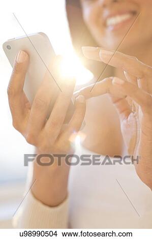 Woman using smartphone. View Large Photo Image Picture - Woman using smartphone.. Fotosearch