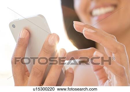 Stock Image - Woman using smartphone.. Fotosearch