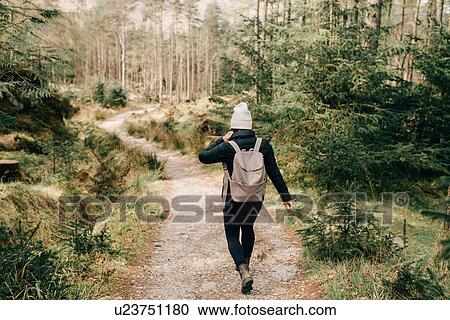 Woman walking through forest, Trossachs National Park, Canada View Large Photo Image Stock Image - Woman walking through forest, Trossachs National Park, Canada. Fotosearch