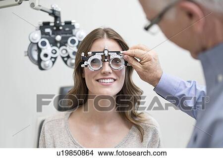 Picture - Woman wearing eyesight testing spectacles.. Fotosearch