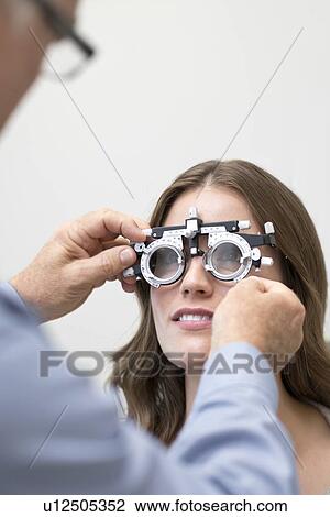 Stock Image - Woman wearing eyesight testing spectacles.. Fotosearch