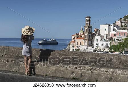Stock Photo - Woman wearing hat by Atrani, Italy. Fotosearch