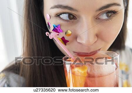 Woman with confetti on cheek drinking cocktail View Large Photo Image Stock Image - Woman with confetti on cheek drinking cocktail. Fotosearch